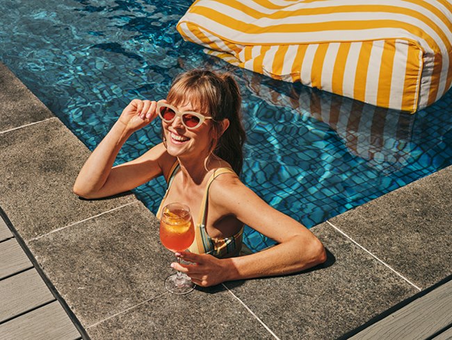 Guest enjoying a cocktail in the LE SPLASH rooftop pool